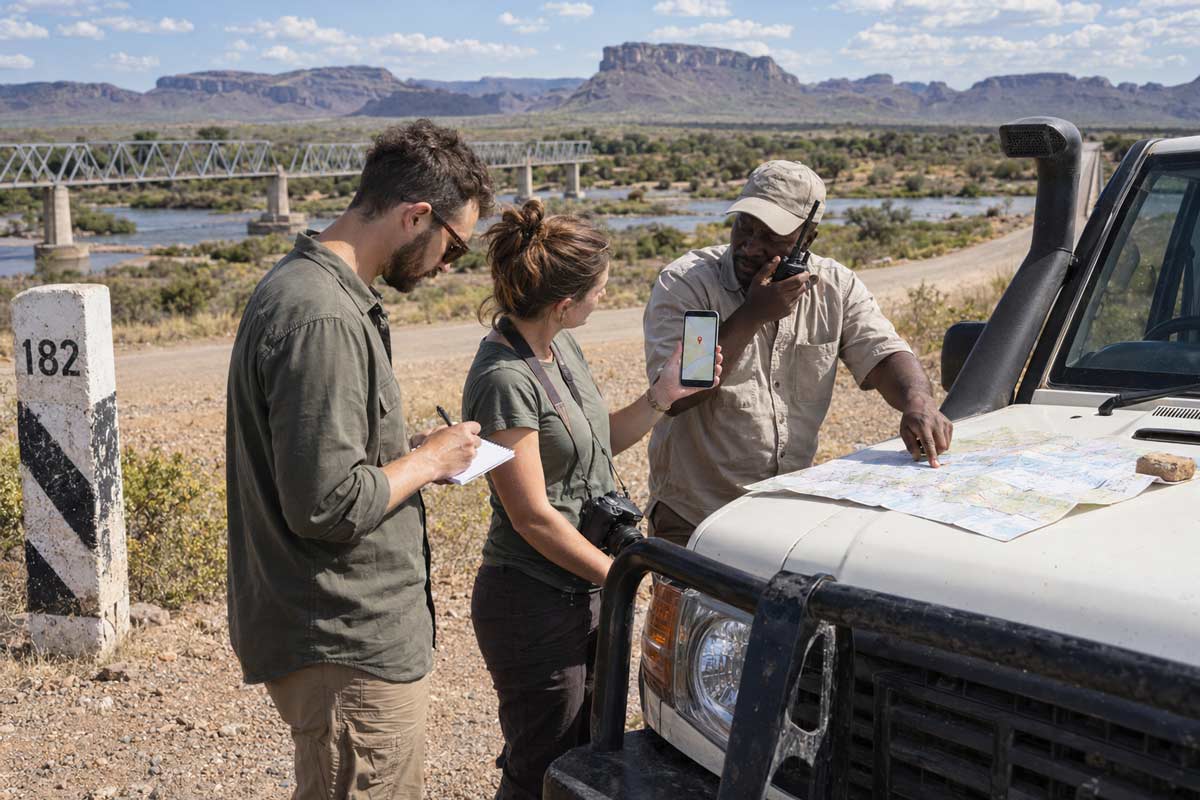 Travellers sharing their GPS location and route details after a road accident on a remote African road.